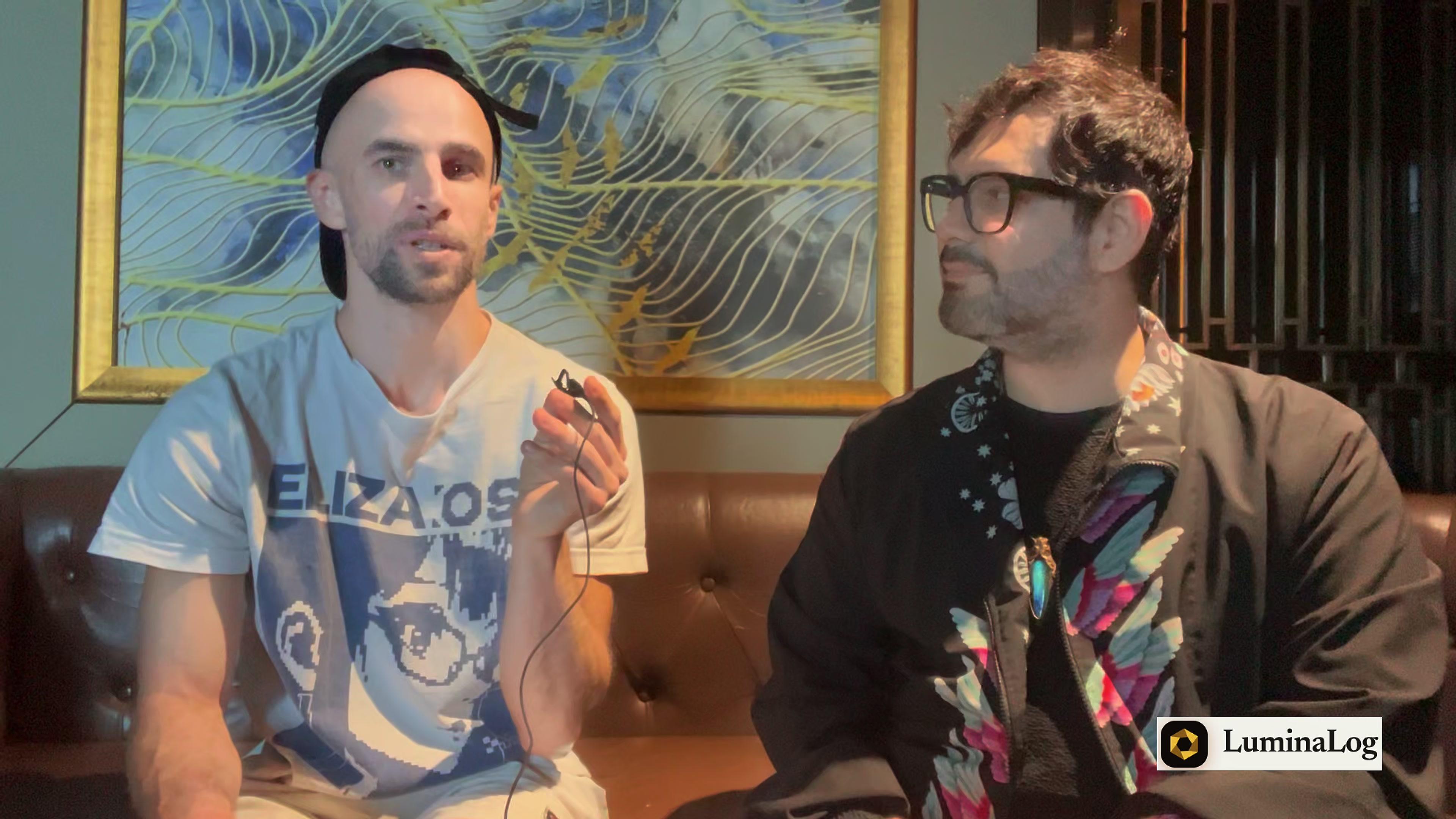 Two people sitting on a couch at Network School at the start of a filmed conversation